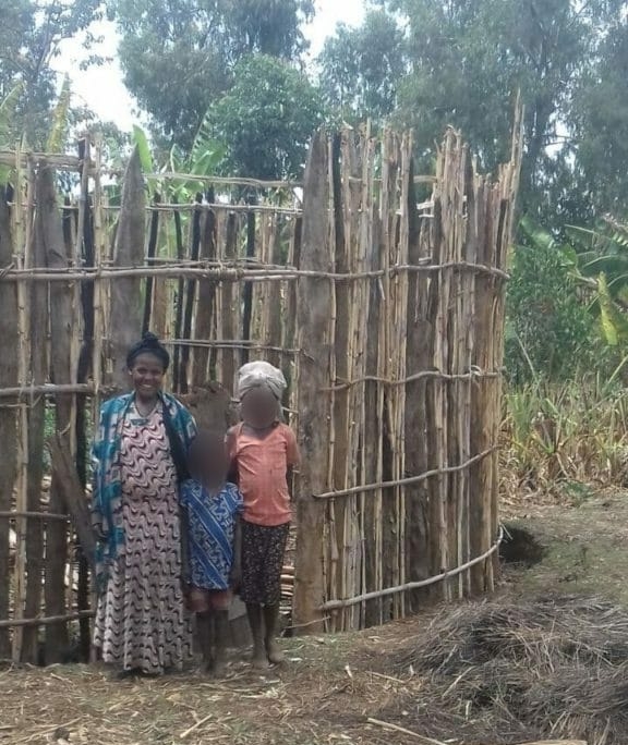 Senia and children outside shop blurred faces 576x1024